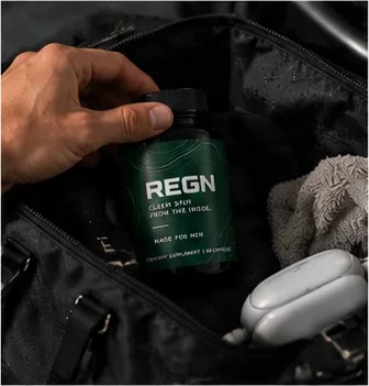 REGN bottle in a gym bag next to earbuds