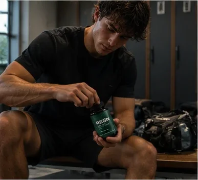 Man in a locker room holding REGN