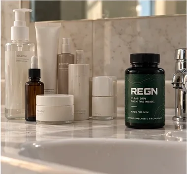 REGN next to skincare bottles on a bathroom shelf